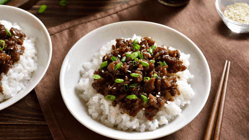 Korean beef bowl served over rice with sesame seeds and green onions- easy 15-minute recipe for busy nights