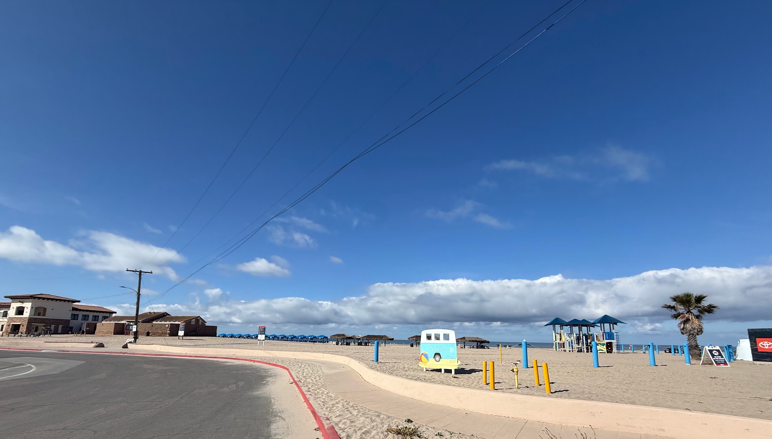 Arrival view at Del Mar Beach Camp Pendleton showing palapas and cabana tents on the sand