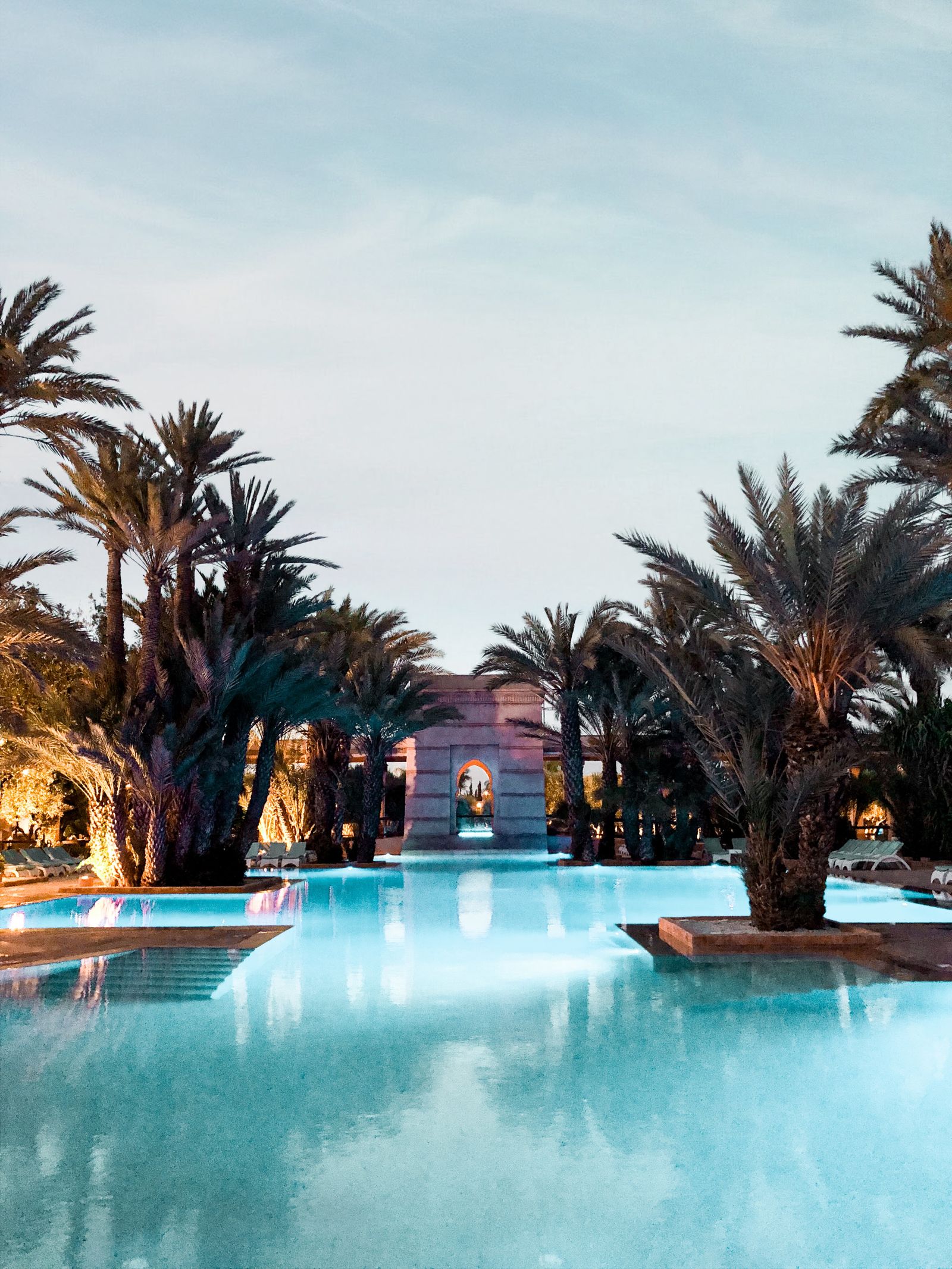 A resort pool lined with palm trees, an Orlando-style family getaway